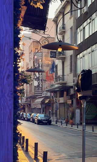 A collection of street furniture, signage, lamps, traffic lights, bollards, illuminated in the late afternoon sunshine.